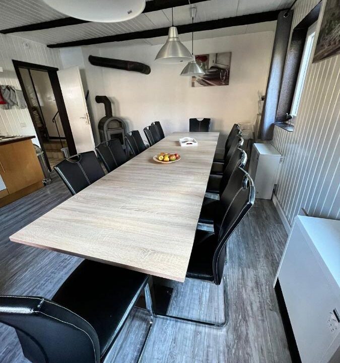 Dining table with fruits and a open fireplace in de back